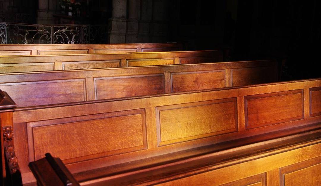 Refinished wooden church pew with renewed stain and sealed finish — church pew refinishing by Atlas Upholstering, Canada