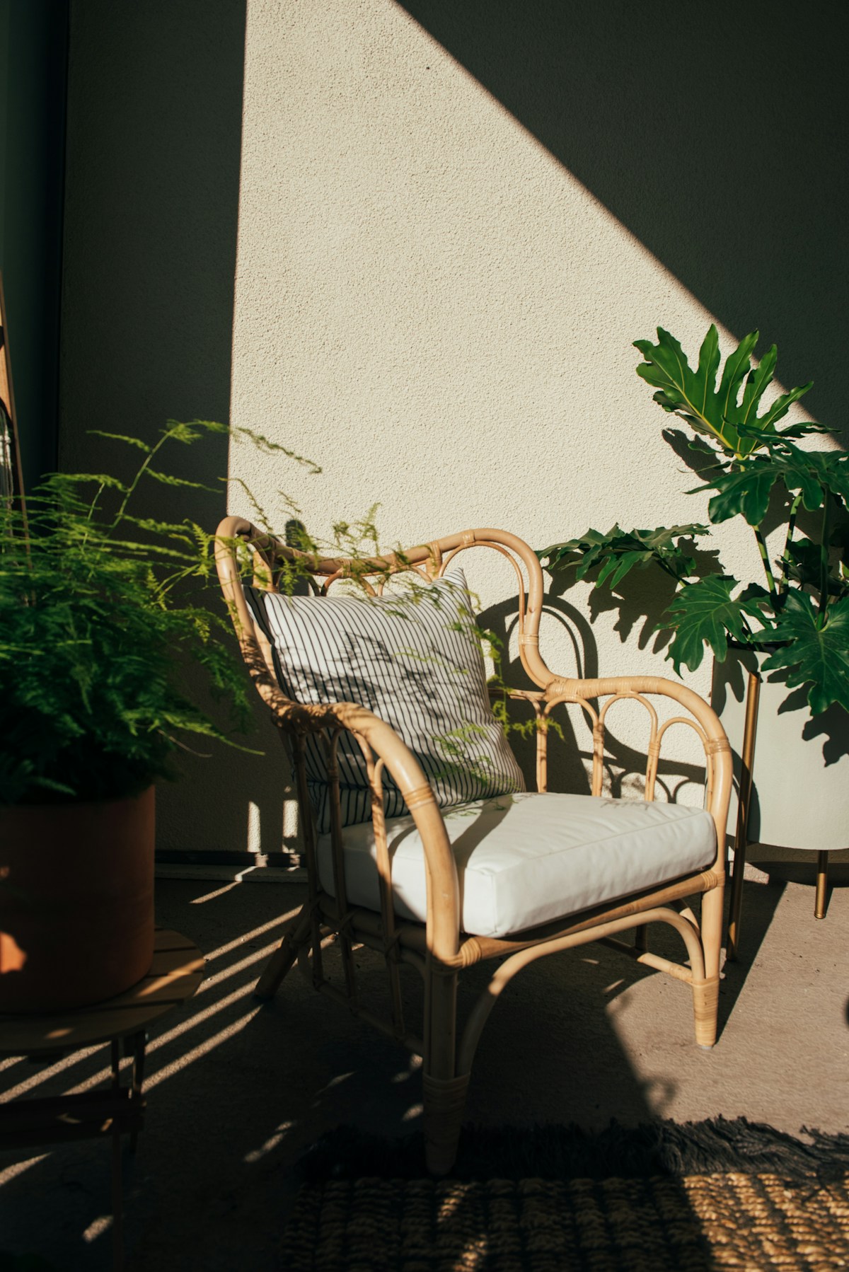 Outdoor rattan chair with custom cushion — outdoor upholstery Montreal by Atlas Upholstering